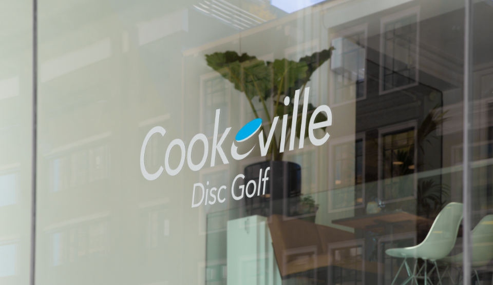 window with the Cookeville Disc Golf Branding